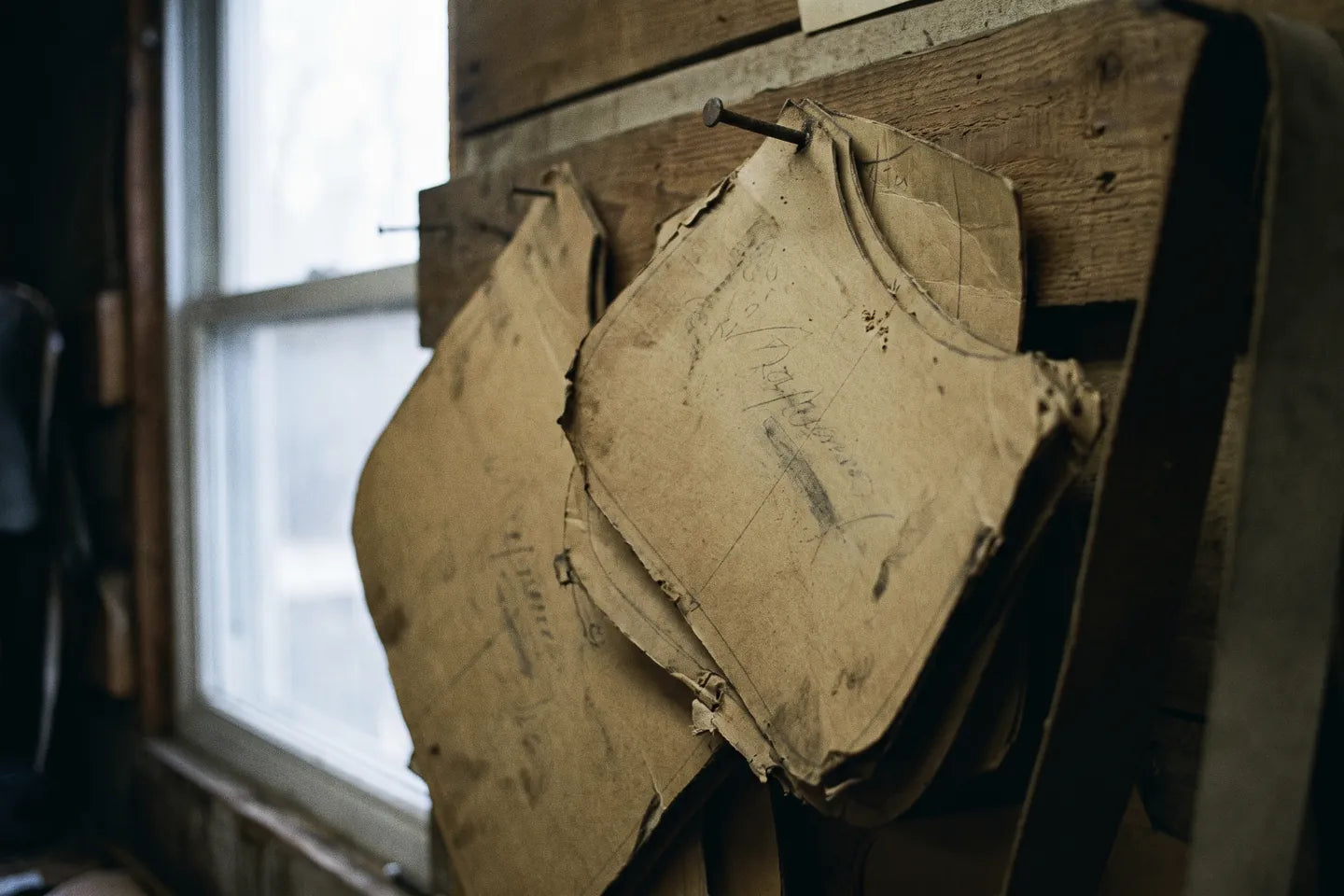A finished bag in its box, the tissue folded back off the grain of the leather.